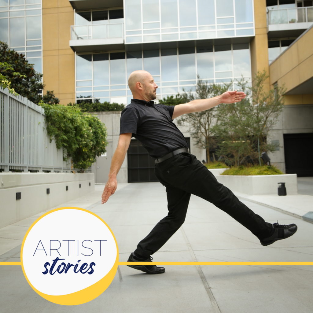 image of man in all black in a artistic dance pose in front of glass buildings